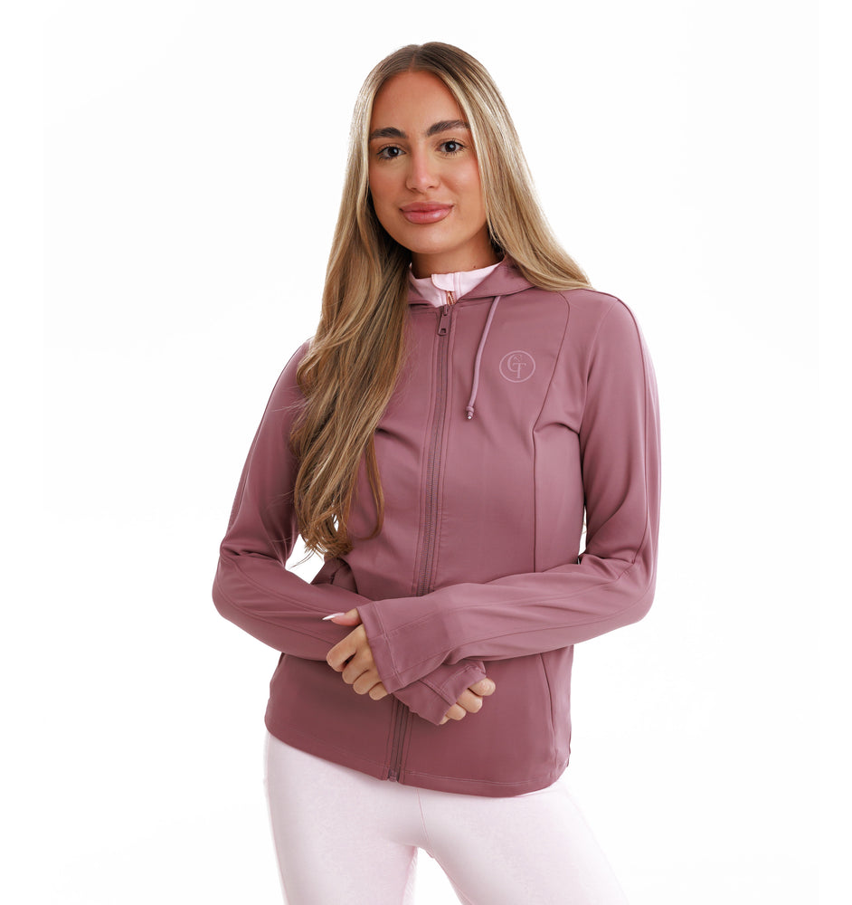 
                  
                    Woman wearing a dark pink hooded jacket with a logo over a light pink outfit on a white background
                  
                