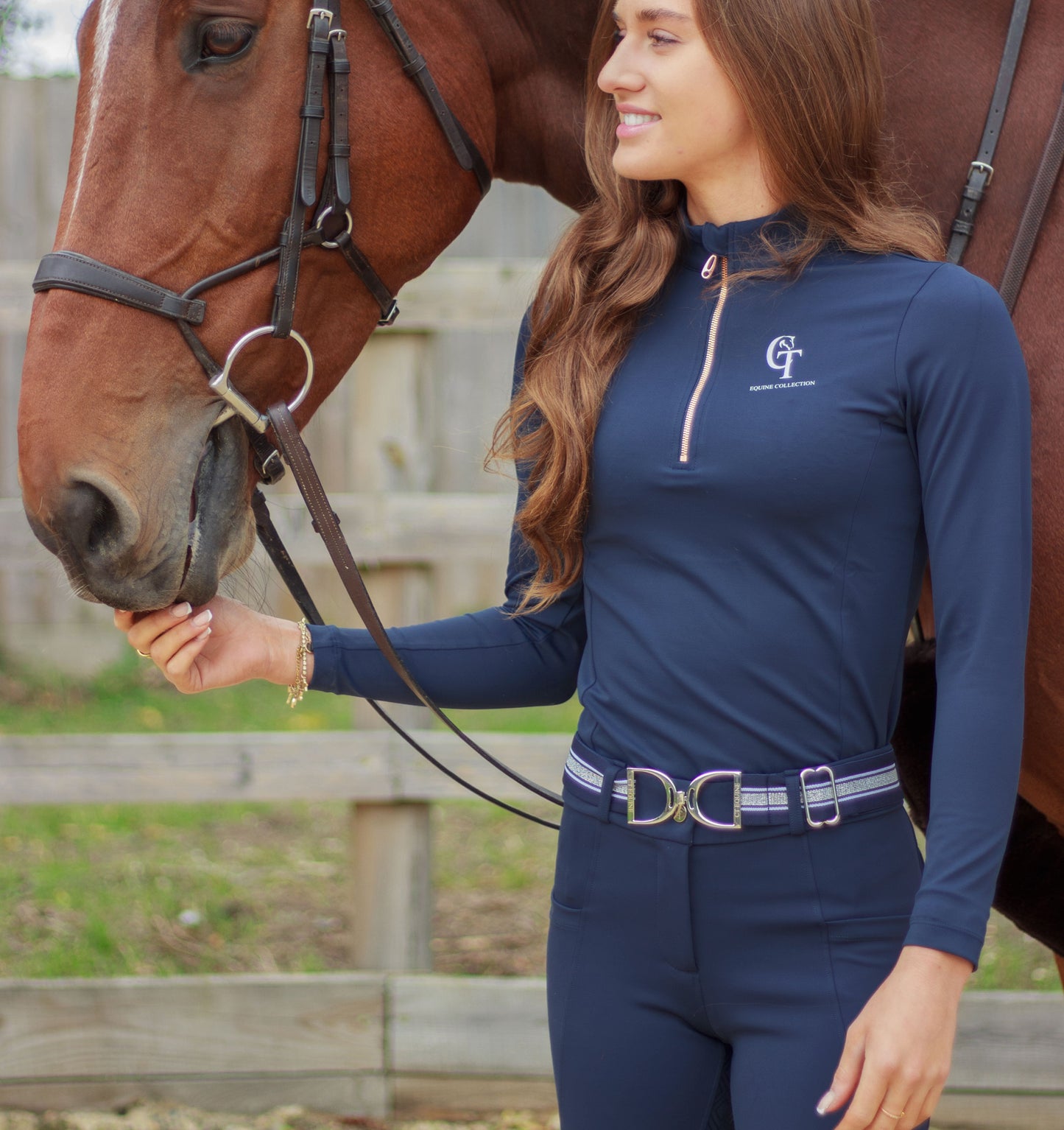 
                  
                    Woman in equestrian attire standing next to a horse
                  
                