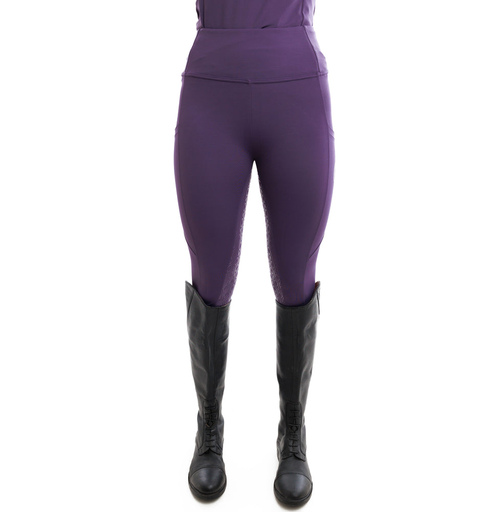 
                  
                    Purple riding pants with black boots on a white background
                  
                