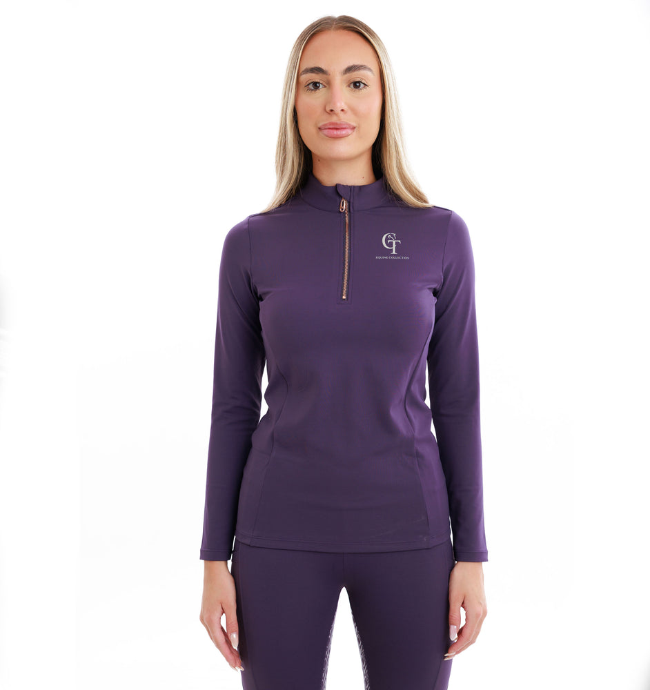 
                  
                    Woman wearing a purple long-sleeve top and matching leggings with a logo on a white background
                  
                