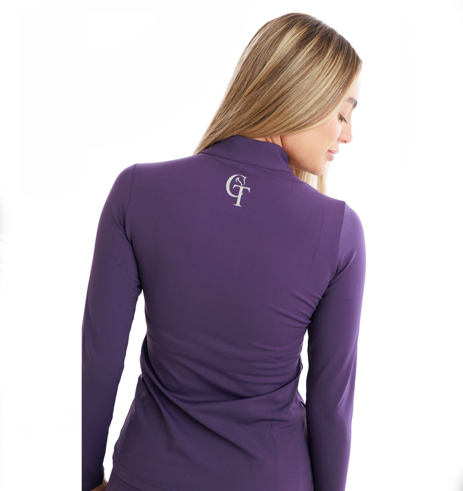 
                  
                    Woman wearing a purple long-sleeve top with a logo on the back against a white background
                  
                