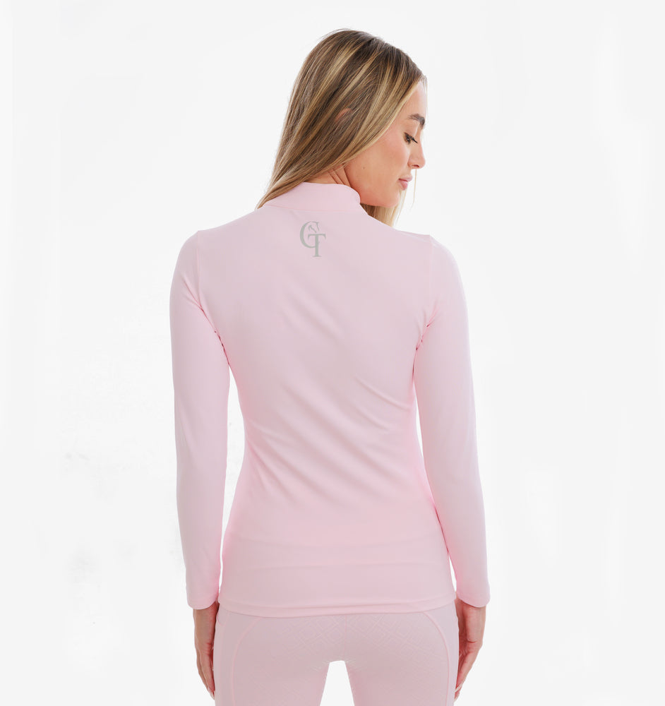 
                  
                    Woman wearing a pink quarter-zip sweatshirt with a logo on the back against a white background
                  
                