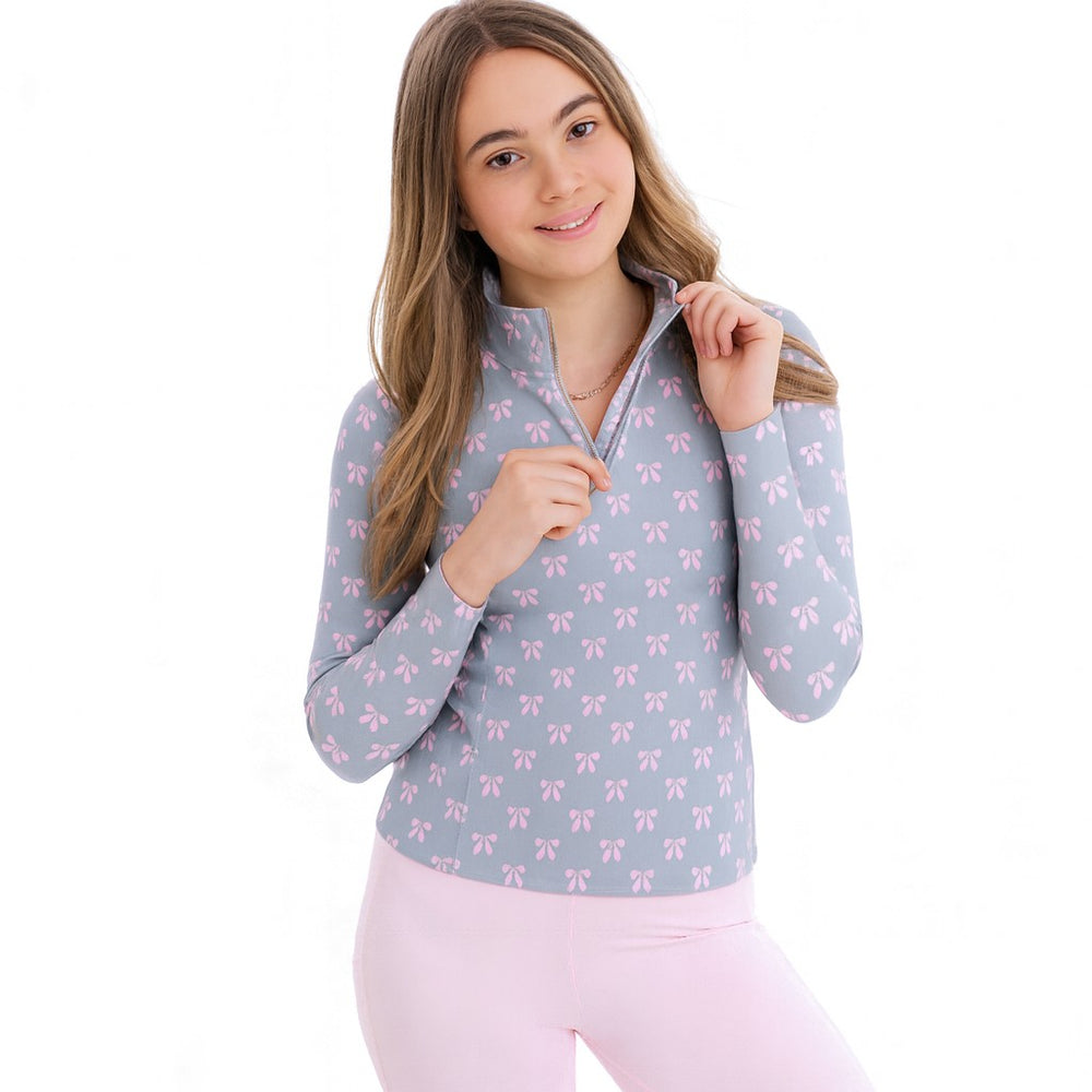 
                  
                    Girl wearing blue long sleeve zip top with pink bows and pink leggings on a white background
                  
                