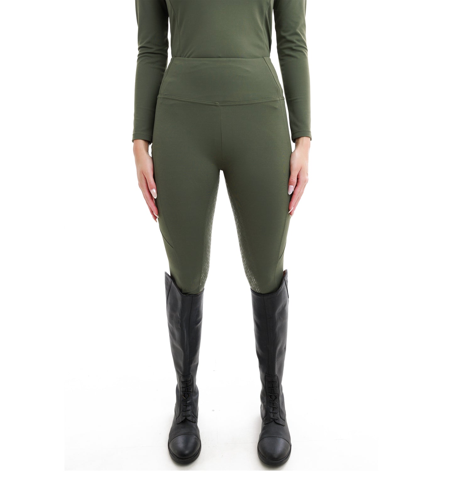 
                  
                    Person wearing green long-sleeve top and leggings with black knee-high boots on a white background
                  
                