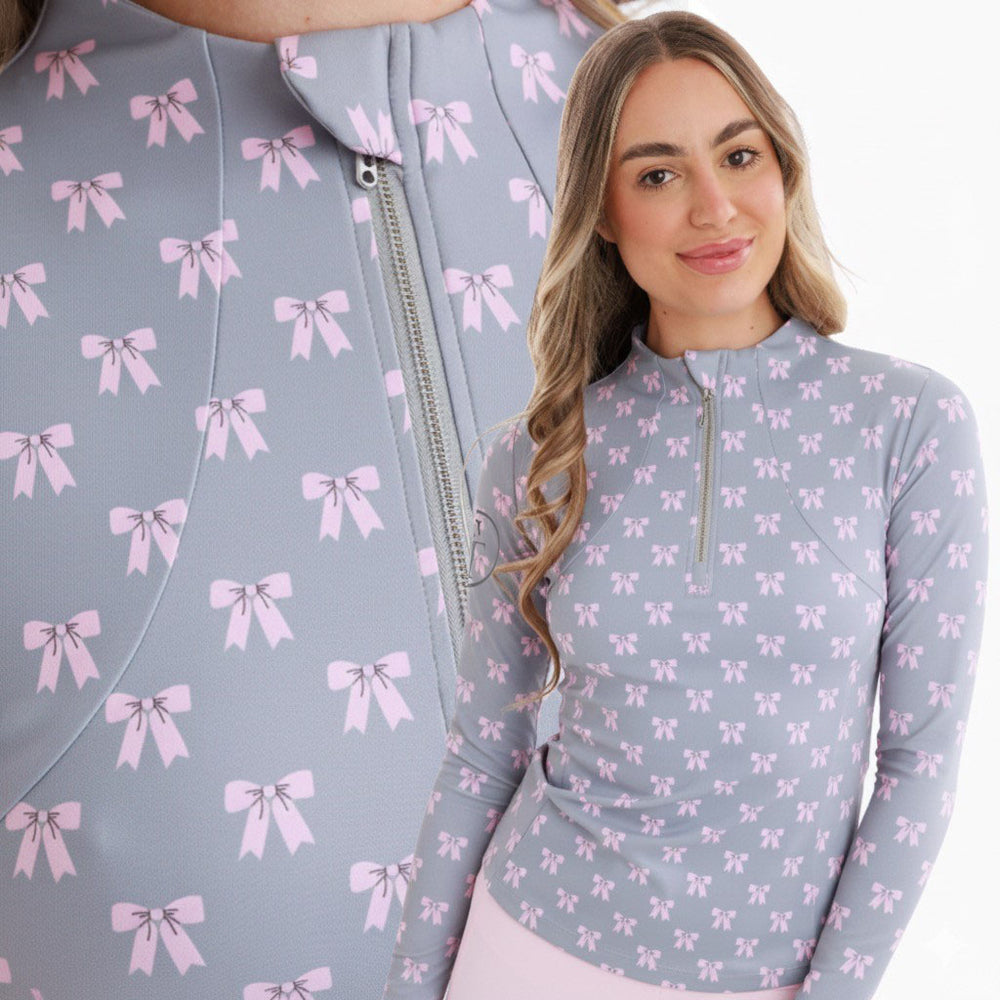 Woman wearing a light blue top with pink bow pattern with zoomed in image of pattern behind 